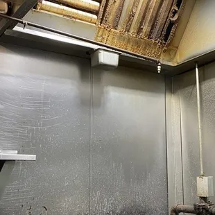 a kitchen with a stove and hood