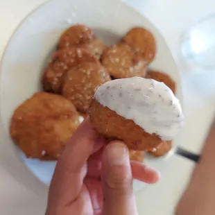 a person holding a donut with a bite taken out of it