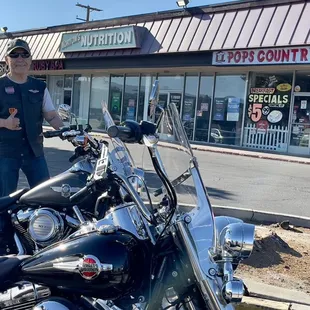 a man standing next to his motorcycle