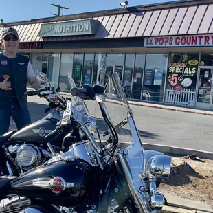 a man standing next to a motorcycle
