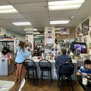 people sitting at tables and eating
