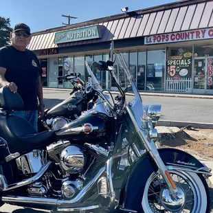 a man standing next to a motorcycle