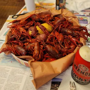 a bowl of boiled crawfish and corn