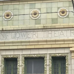 a sunflower theater sign on the side of a building