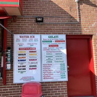 a menu on a brick wall