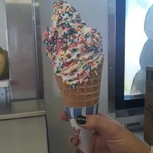 an ice cream cone with sprinkles