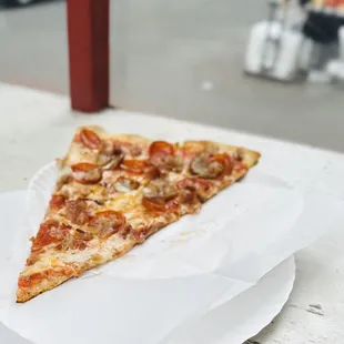 Meat lovers slice, truly thin, bottom is crispy, the perfect slice of what New York pizza oughta be!
