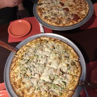 wo pizzas on a table