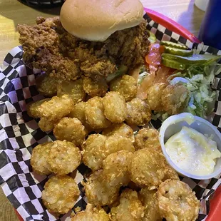 Fried breaded pork tenderloin and tots. Lettuce, Tom, pickles and Mayo are extra