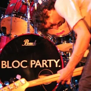 a man playing a guitar on stage