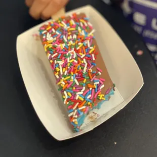 Bubble gum pop dipped in milk chocolate and rainbow sprinkles