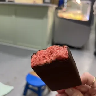 Strawberry popsicle dipped in dark chocolate