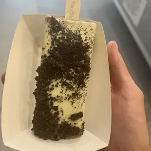 Oreo popsicle, dipped in white chocolate with Oreo crumbles