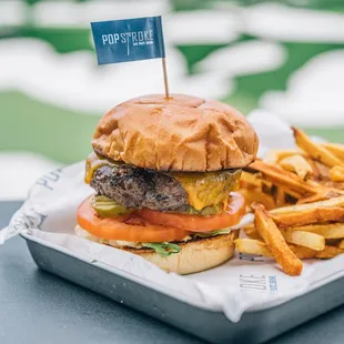 a cheeseburger and fries on a tray