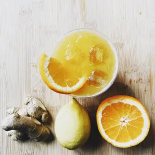 a bowl of orange juice and sliced lemons