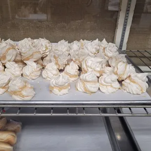 a tray of meringue on a conveyor belt