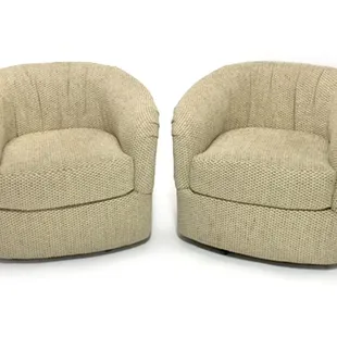 This matching pair of soft and comfy barrel chairs are covered in creamy tan fabric and swivel 360 degrees smoothly. Each chair measures 27