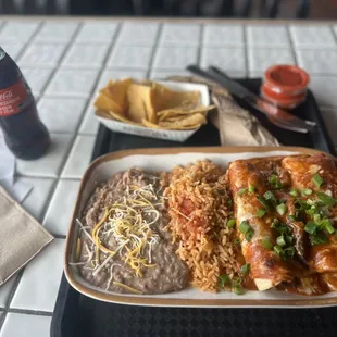 a plate of food and a bottle of coke