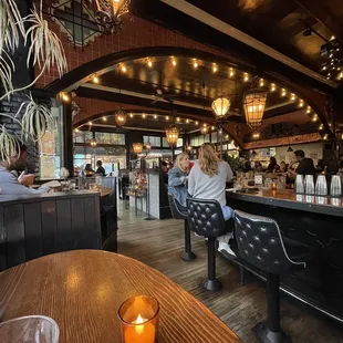 people sitting at the bar in a restaurant