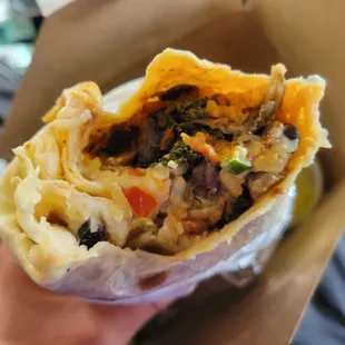 Bites out of the kale and mushroom burrito