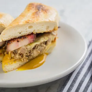 P.I.G. Smoked pulled pork, thick-cut bacon, aged swiss, carolina gold sauce, bread and butter pickles