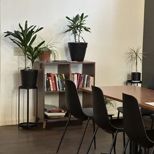 a table with chairs and bookshelves