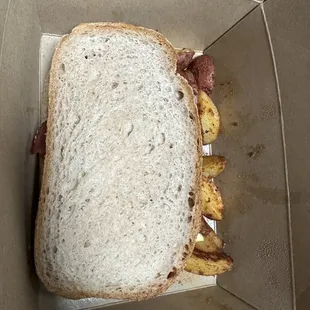 Breakfast sandwich on gluten free bread with potatoes