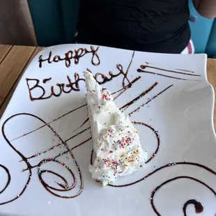 It was a member of our party&apos;s birthday day. When they sang they brought out a piece of cake with happy birthday written on the plate.