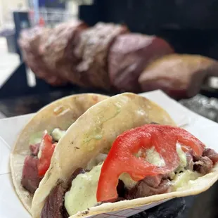 two tacos on a paper plate