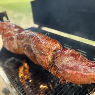 the meat being cooked on the grill