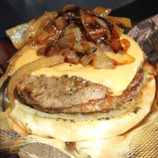 a hamburger with onions and cheese