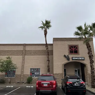 two cars parked in front of a restaurant