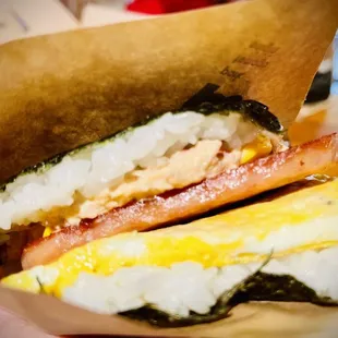 a close up of a sandwich in a paper bag