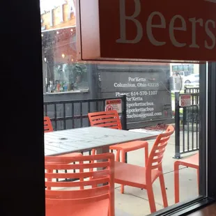 a table and chairs outside of a craft beer shop