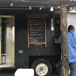 a man standing in front of a food truck