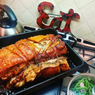 a roasting pan with meat and vegetables