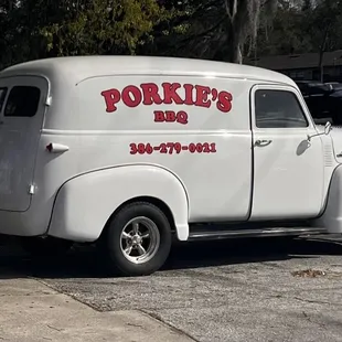 a white truck parked next to a red car
