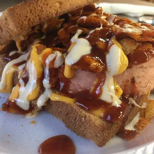 Pop's Porkland Round Steak - thick chunk of fried bologna with Grippos, nacho cheese, and barbecue sauce.