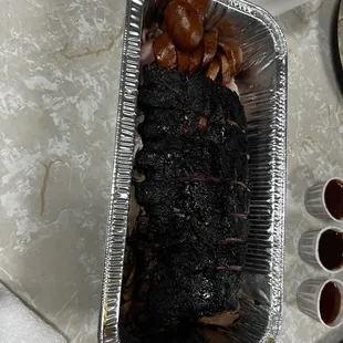 Meat was served in this container covered with foil. It does not look like much but fed four people.