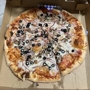 a pizza with olives and onions