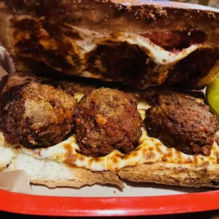 a meatball sandwich and pickles