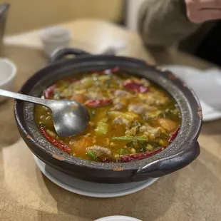 a bowl of soup with a spoon