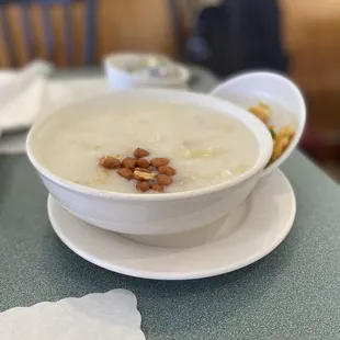 a bowl of porridge with nuts on top