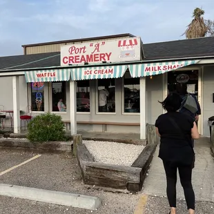 a woman standing in front of a store