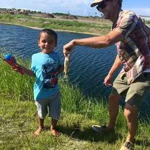 Ryan helping Camden hold up his catch for a picture before release