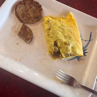 Sausage and cheese omelet with a side of sausage.  This normally has hash browns and toast too but I had them hold them.