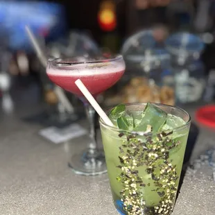 two cocktails on a bar