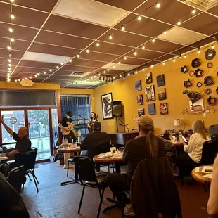 a group of people sitting at tables in a restaurant