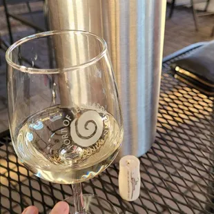 a hand holding a wine glass