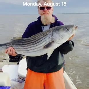 a man holding a fish